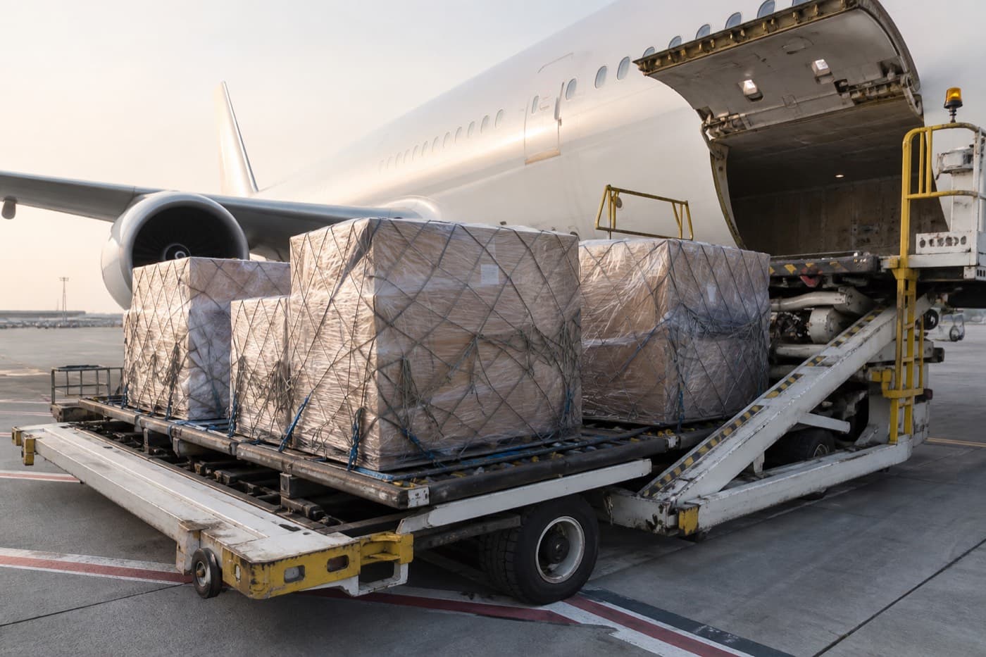 Air cargo cartons on airport trolley for international shipping from India